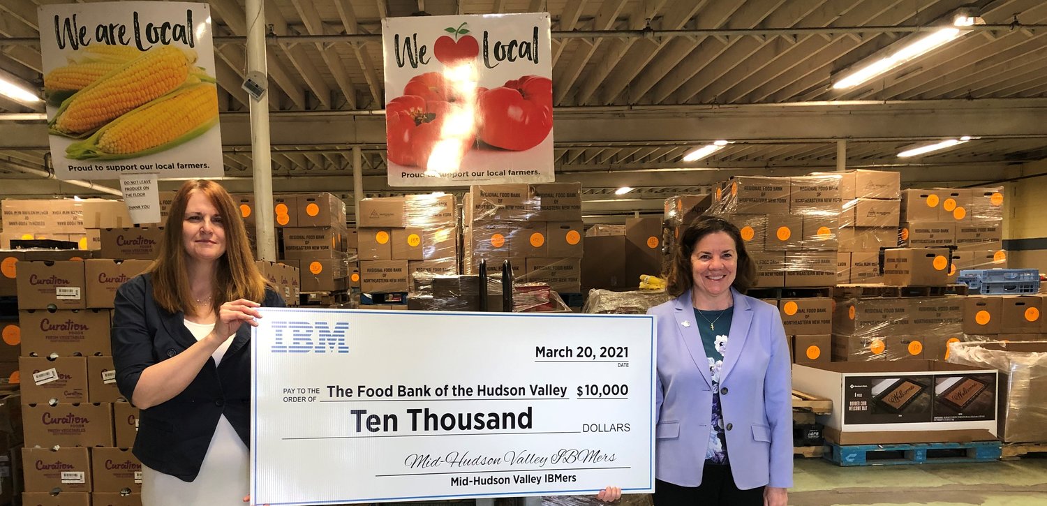 Food Bank of the Hudson Valley Director Sara Gunn, left, receives a $10,000 check from IBM Senior Location Executive Maria Boonie.